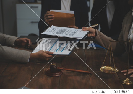 Judge gavel with Justice lawyers having team meeting at law firm background. Concepts of Law and Legal services. 115319684