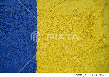 The wall is painted blue and yellow. High quality photo 115319875