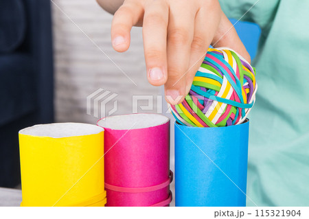 Preschooler hands with ball of rubber bands or erasers Preschooler hands with ball of rubber bands or erasers 115321904