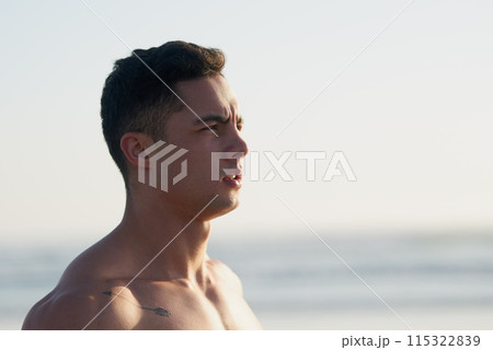 Fitness, thinking and man on beach in morning for workout, exercise and training outdoors for surfing. Nature, athlete and confident person by sea and ocean for wellness, health and water sports 115322839