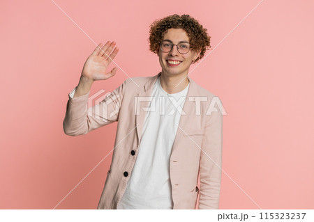 Happy man smiling friendly waving hands gesturing hello greeting or goodbye, meeting invitation Happy man smiling friendly waving hands gesturing hello greeting or goodbye, meeting invitation 115323237