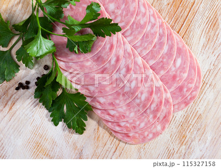 Appetizing thin slices of boiled pork sausage Appetizing thin slices of boiled pork sausage 115327158