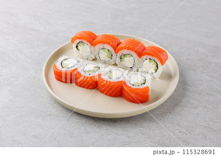 Sushi roll (Philadelphia) with salmon, cream cheese, Sushi menu. Japanese food. Sushi roll (Philadelphia) with salmon, cream cheese, Sushi menu. Japanese food. 115328691