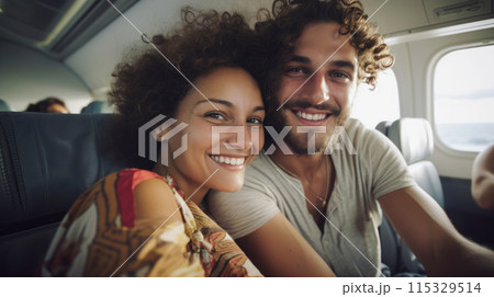 Cheerful young adult couple travelling by train, responsible travel concept 115329514