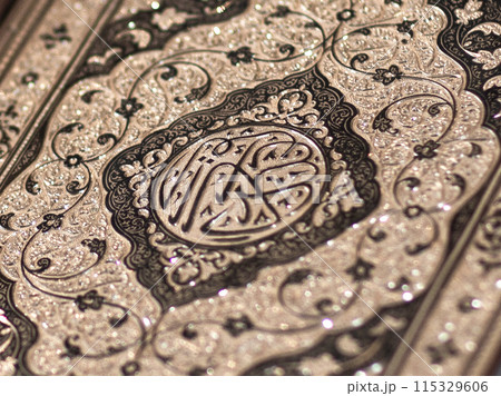 Islamic Book Quran with golden arabic calligraphy that means Al-Quran 115329606