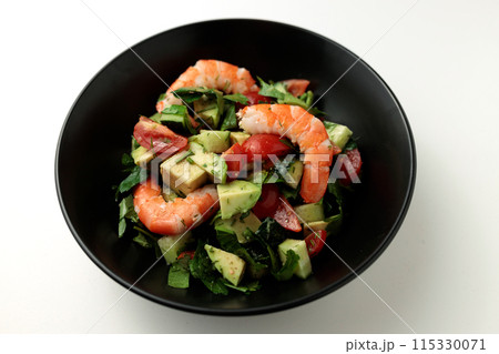 Salad of king prawns, avocado, cucumber, tomato and herbs. Isolated background. 115330071
