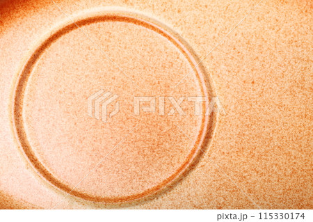 brown ceramic saucer on white background 115330174
