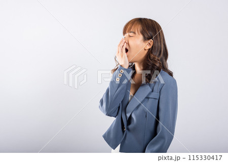 Portrait Asian beautiful young business woman emotions tired and sleepy her yawning covering mouth open by hand, studio shot isolated on white background, Female insomnia concept with copy space 115330417