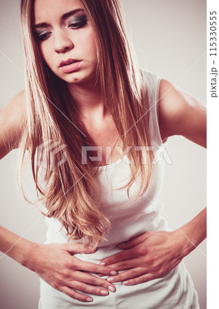 Girl suffering from stomach pain 115330555