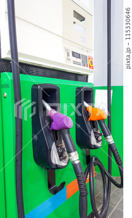 Various gas pump nozzles in different colors for each type of fuel in a gas station Various gas pump nozzles in different colors for each type of fuel in a gas station 115330646