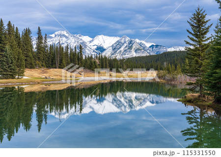 Cascade Ponds park in autumn sunny day, snow-covered Mount Astley reflection on the water surface. Banff National Park, Canadian Rockies, Alberta, Canada. Cascade Ponds park in autumn sunny day, snow-covered Mount Astley reflection on the water surface. Banff National Park, Canadian Rockies, Alberta, Canada. 115331550