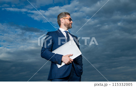 handsome freelancer man with laptop outdoor. freelancer man with laptop wearing suit. handsome freelancer man with laptop outdoor. freelancer man with laptop wearing suit. 115332005