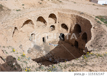 Ancient Berber dwellings carved into walls of earthen pit in Matmata Ancient Berber dwellings carved into walls of earthen pit in Matmata 115332147