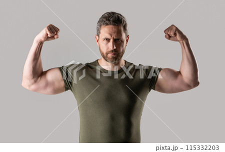 muscular strong man in studio. photo of strong muscular man with stubble. strong muscular man muscular strong man in studio. photo of strong muscular man with stubble. strong muscular man 115332203