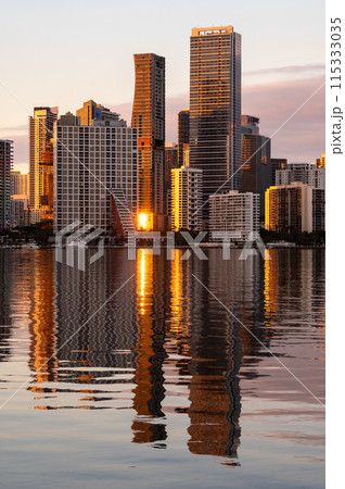 City of Miami, Florida skyline at sunset reflected in calm Biscayne Bay. 115333035