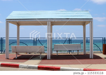 Sun canopy in a city park on the seashore. 115333118