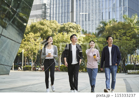 group of young asian people talking chatting while walking on street 115333237