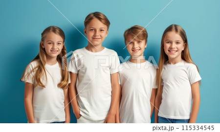 A group of four children, two boys and two girls, are standing in front of a blue background. 115334545