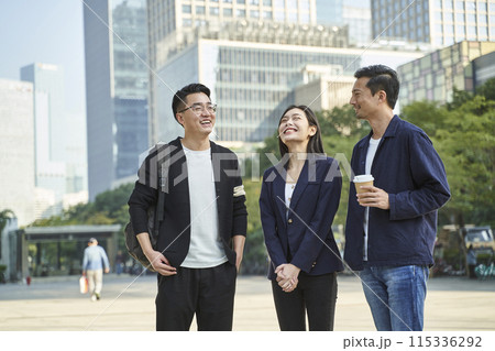 young asian adults standing talking on street 115336292