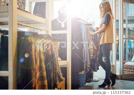 Fashion, shopping or woman in clothes store for decision, sales or discount at luxury mall. Rich, retail shop or customer with fabric at boutique or showroom on rack for purchase choice on promotion 115337362