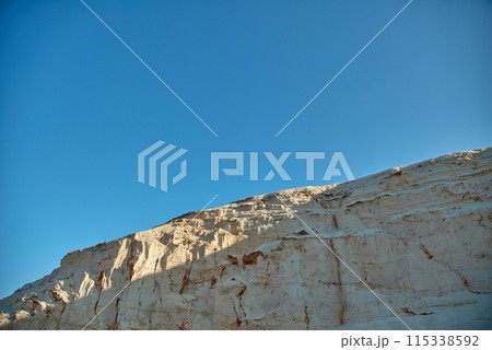 Breathtaking White Cliff Against Clear Blue Sky 115338592
