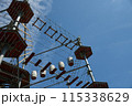 Rustic Ferris Wheel against Blue Sky in Vintage Amusement Park 115338629