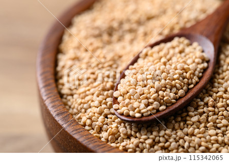 Brown quinoa seed in wooden bowl with spoon, Healthy food ingredient Brown quinoa seed in wooden bowl with spoon, Healthy food ingredient 115342065