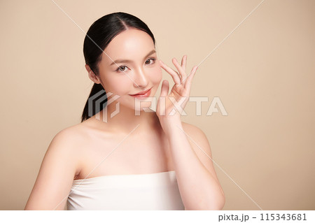 Beautiful young asian woman with clean fresh skin on beige background, Face care, Facial treatment, Cosmetology, beauty and spa, Asian women portrait. Beautiful young asian woman with clean fresh skin on beige background, Face care, Facial treatment, Cosmetology, beauty and spa, Asian women portrait. 115343681
