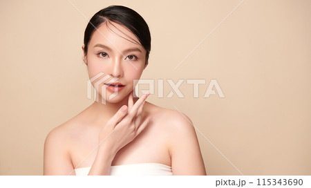 Beautiful young asian woman with clean fresh skin on beige background, Face care, Facial treatment, Cosmetology, beauty and spa, Asian women portrait. Beautiful young asian woman with clean fresh skin on beige background, Face care, Facial treatment, Cosmetology, beauty and spa, Asian women portrait. 115343690