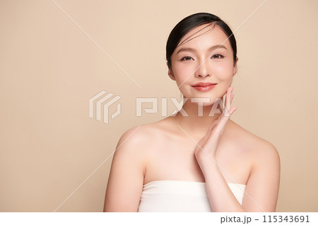 Beautiful young asian woman with clean fresh skin on beige background, Face care, Facial treatment, Cosmetology, beauty and spa, Asian women portrait. 115343691