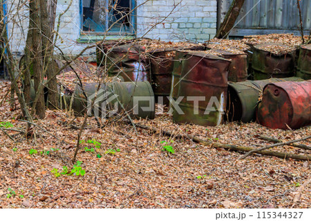 Old rusty barrels in the ghost town Pripyat in Chernobyl Exclusion Zone, Ukraine 115344327