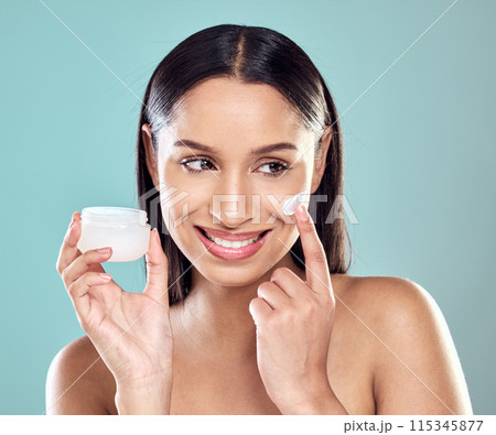 Woman, lotion and apply jar of spf in studio, hydration and cleaning or skincare on blue background. Female person, beauty and cream for facial treatment in container, pamper routine and sunscreen Woman, lotion and apply jar of spf in studio, hydration and cleaning or skincare on blue background. Female person, beauty and cream for facial treatment in container, pamper routine and sunscreen 115345877