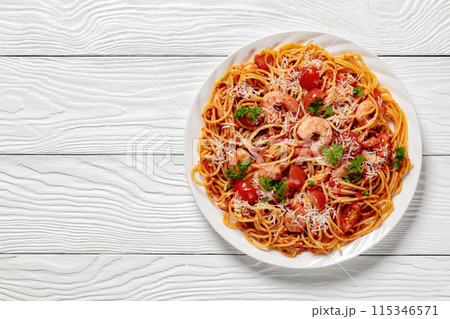 shrimp fra diavolo with spaghetti on a plate 115346571