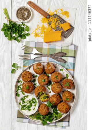 fried broccoli cheese balls with sour cream sauce 115346574