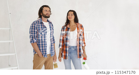Couple Ready to Start Painting Walls in Home Renovation Project Couple Ready to Start Painting Walls in Home Renovation Project 115347170