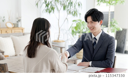 訪問営業で握手をするビジネスマン 115347330