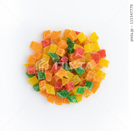 heap of candied fruit pieces close up on white background heap of candied fruit pieces close up on white background 115347779