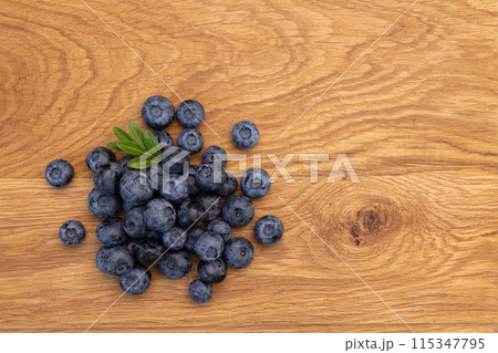 heap of ripe blueberries on wooden background heap of ripe blueberries on wooden background 115347795