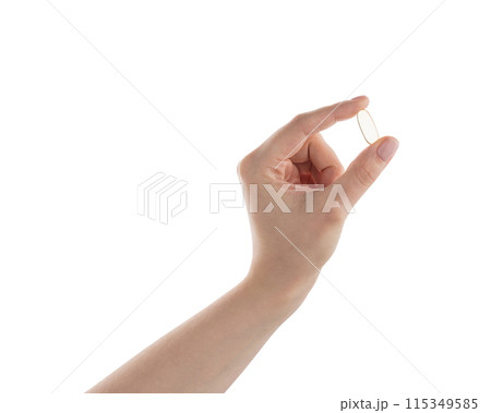 Female hand hold transparent pill isolated on white 115349585