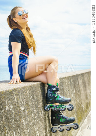 Girl wearing roller skates on seaside 115349883