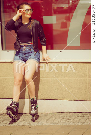 Woman wearing roller skates next to sale Woman wearing roller skates next to sale 115350477