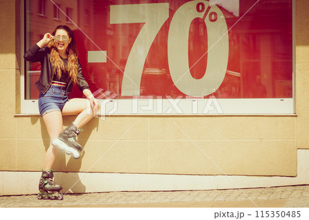 Woman wearing roller skates next to sale 115350485