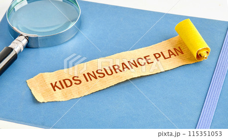 KIP kids insurance plan symbol on a note made of paper on a blue business notebook 115351053