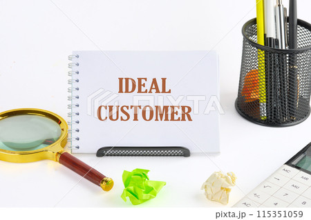 Business ideal customer concept. Copy space. Ideal customer symbol on a notepad standing on a stand Business ideal customer concept. Copy space. Ideal customer symbol on a notepad standing on a stand 115351059