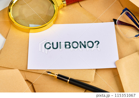 CUI BONO (to whose benefit) question on a blank sheet near a pen, magnifying glass and glasses 115351067