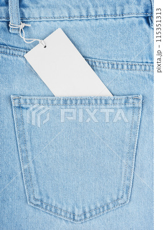 Back side pocket on blue jeans pants and blank price tag closeup background, mockup, copy space Back side pocket on blue jeans pants and blank price tag closeup background, mockup, copy space 115351313