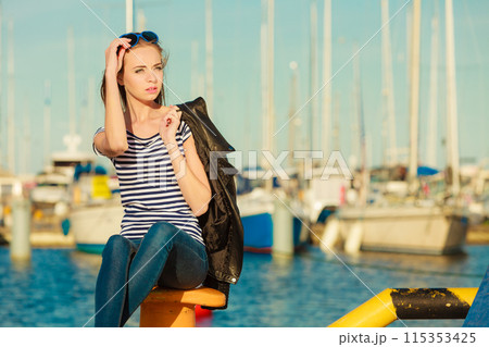 woman in marina against yachts in port 115353425