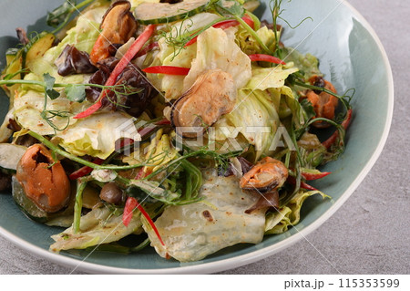 Salad with mussel, iceberg lettuce, dressed with top selling nut sauce for restaurant and café 115353599