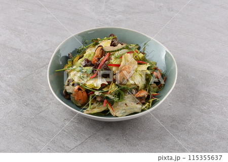 Salad with mussel, iceberg lettuce, dressed with top selling nut sauce for restaurant and café Salad with mussel, iceberg lettuce, dressed with top selling nut sauce for restaurant and café 115355637