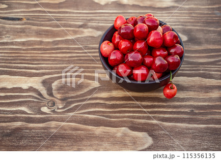 ripe cherries on blue wooden background, copy space 115356135